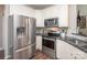 Well-equipped kitchen featuring stainless steel refrigerator, oven, and white cabinetry at 1304 Hammond Dr, Matthews, NC 28104