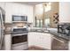 Charming kitchen featuring stainless steel appliances, granite counters and white cabinetry at 1304 Hammond Dr, Matthews, NC 28104