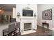 Cozy living room with fireplace, flatscreen television, bar seating and attractive wall decorations at 1304 Hammond Dr, Matthews, NC 28104