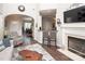 Cozy living room with fireplace, modern furniture, and seamless flow into kitchen creates an inviting space at 1304 Hammond Dr, Matthews, NC 28104