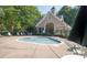 Relaxing smaller outdoor pool surrounded by lounge chairs and a shaded area at 1304 Hammond Dr, Matthews, NC 28104