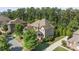 Beautiful aerial view of a large house with mature trees, well-kept lawn, and a cul-de-sac at 16522 Flintrock Falls Ln, Charlotte, NC 28278
