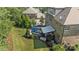 Aerial view of the brick home showcasing the backyard, deck, and patio with outdoor furniture at 16522 Flintrock Falls Ln, Charlotte, NC 28278