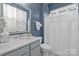 Well-lit bathroom featuring a walk-in shower, marble countertop, and contemporary finishes at 16522 Flintrock Falls Ln, Charlotte, NC 28278