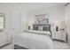 A bright bedroom with a plush bed, neutral color palette, and artwork creating a serene atmosphere at 16522 Flintrock Falls Ln, Charlotte, NC 28278
