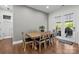 Dining room includes hardwood floors, wooden chairs, a wooden table, and access to the backyard at 16522 Flintrock Falls Ln, Charlotte, NC 28278
