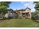 Beautiful stone home features a well-manicured lawn and a charming covered front porch at 16522 Flintrock Falls Ln, Charlotte, NC 28278