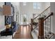Elegant foyer with a wooden staircase, high ceilings, and views of the outdoors at 16522 Flintrock Falls Ln, Charlotte, NC 28278