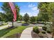Well-maintained yard with a winding sidewalk and lush green trees at 16522 Flintrock Falls Ln, Charlotte, NC 28278