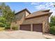 Three-car garage showcasing brick exterior and well-maintained landscaping at 16522 Flintrock Falls Ln, Charlotte, NC 28278