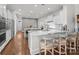 Spacious kitchen boasts a center island, stainless steel appliances, bar seating and hardwood floors at 16522 Flintrock Falls Ln, Charlotte, NC 28278