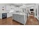 Bright kitchen features a center island, stainless steel appliances, and hardwood floors at 16522 Flintrock Falls Ln, Charlotte, NC 28278