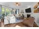 The living room features a fireplace, a TV, a white couch, a leather chair, and hardwood floors at 16522 Flintrock Falls Ln, Charlotte, NC 28278
