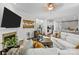 Bright, open living room with a modern fireplace, wood floors, and a seamless flow into the kitchen at 16522 Flintrock Falls Ln, Charlotte, NC 28278