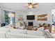 The living room features a fireplace, a TV, a white couch, and hardwood floors at 16522 Flintrock Falls Ln, Charlotte, NC 28278