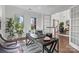 Cozy office space with a dark desk and large windows overlooking the front yard at 16522 Flintrock Falls Ln, Charlotte, NC 28278