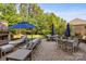 Relaxing backyard patio features ample seating, patio tables, and an outdoor fireplace at 16522 Flintrock Falls Ln, Charlotte, NC 28278
