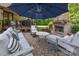 Outdoor patio with comfortable seating, tables, a brick fireplace, and a grill at 16522 Flintrock Falls Ln, Charlotte, NC 28278