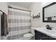 Small bathroom with a striped shower curtain, dark fixtures, and a vanity with a vessel sink at 17711 North Shore Cir, Cornelius, NC 28031