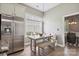Bright breakfast nook features a built-in bench, wood table, pendant light, and stainless steel refrigerator at 17711 North Shore Cir, Cornelius, NC 28031