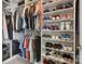 Walk-in closet with organized shelving and hanging space, showcasing a variety of clothing and shoes at 17711 North Shore Cir, Cornelius, NC 28031