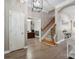 Inviting foyer with hardwood floors, staircase, and elegant lighting, showcasing a welcoming entrance at 17711 North Shore Cir, Cornelius, NC 28031