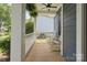 Cozy front porch with white rocking chairs and a ceiling fan, perfect for relaxing outdoors at 17711 North Shore Cir, Cornelius, NC 28031