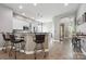 Open-concept kitchen with bar seating, white cabinets, and hardwood floors, ideal for gatherings at 17711 North Shore Cir, Cornelius, NC 28031