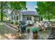Backyard with patio, grill, dining table, cushioned outdoor seating, and manicured flowerbeds at 18439 Victoria Bay Dr, Cornelius, NC 28031