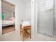 Bright bathroom with glass shower and a wooden bench at 18439 Victoria Bay Dr, Cornelius, NC 28031
