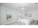 Bright bedroom features two windows with outdoor views, ceiling fan and white linens at 18439 Victoria Bay Dr, Cornelius, NC 28031