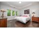 Light-filled bedroom with dark wood floors and large windows at 18439 Victoria Bay Dr, Cornelius, NC 28031