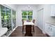 Cozy breakfast nook with large windows, modern lighting, and backyard views at 18439 Victoria Bay Dr, Cornelius, NC 28031
