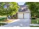 Charming two-story home featuring a well-maintained lawn, a two-car garage, and dormer windows at 18439 Victoria Bay Dr, Cornelius, NC 28031