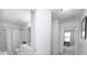 Hallway featuring a door to a full bathroom with double vanity and a view to another room at 18439 Victoria Bay Dr, Cornelius, NC 28031