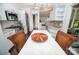 Eat-in kitchen with white marble counters, stainless appliances and wood floors at 18439 Victoria Bay Dr, Cornelius, NC 28031