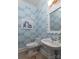 Charming powder room with whimsical wallpaper, pedestal sink, and elegant white framed mirror at 18534 Carnegie Overlook Blvd # 110, Davidson, NC 28036