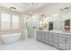 Luxurious bathroom featuring a standalone tub, glass-enclosed shower, and double vanity with modern fixtures at 18534 Carnegie Overlook Blvd # 110, Davidson, NC 28036