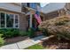 Welcoming front porch with red brick and American flag at 18534 Carnegie Overlook Blvd # 110, Davidson, NC 28036