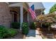 Front porch with decorative bushes and an American flag at 18534 Carnegie Overlook Blvd # 110, Davidson, NC 28036