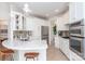 Well-lit kitchen with marble countertops, stainless steel appliances, and an open view to the rest of the house at 18534 Carnegie Overlook Blvd # 110, Davidson, NC 28036