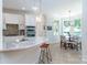 Bright and spacious kitchen with marble countertops, stainless steel appliances, and an adjacent dining area with bay windows at 18534 Carnegie Overlook Blvd # 110, Davidson, NC 28036