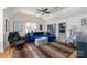 Cozy living room featuring built-in bookshelves, a blue sectional, and a unique patterned rug at 18534 Carnegie Overlook Blvd # 110, Davidson, NC 28036