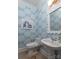 Charming powder room featuring a pedestal sink, toilet, intricate mirror, and patterned wallpaper at 18534 Carnegie Overlook Blvd # 110, Davidson, NC 28036