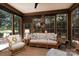Inviting sunroom with multiple windows, comfortable wicker seating, and a ceiling fan at 18534 Carnegie Overlook Blvd # 110, Davidson, NC 28036