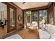 Cozy sunroom filled with natural light, brick accent wall, and comfortable seating area perfect for relaxation at 18534 Carnegie Overlook Blvd # 110, Davidson, NC 28036