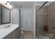 Well-lit bathroom with elegant vanity, shower, and coordinated fixtures at 18730 Nautical Dr # 102, Cornelius, NC 28031