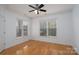 Bright bedroom with hardwood floors and abundant natural light from large windows at 18730 Nautical Dr # 102, Cornelius, NC 28031