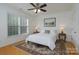 Cozy bedroom with a plush rug, queen bed, and serene artwork at 18730 Nautical Dr # 102, Cornelius, NC 28031