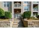 Inviting entryway with stone steps and manicured landscaping leading to gated entrance to multi story condo at 18730 Nautical Dr # 102, Cornelius, NC 28031